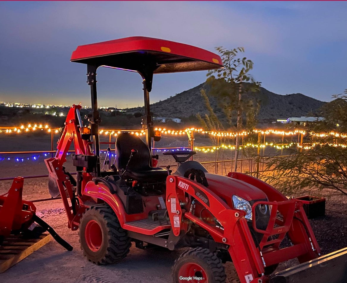 KIOTI tractor equipped with a Tractor Sunshade N-Series fiberglass canopy.