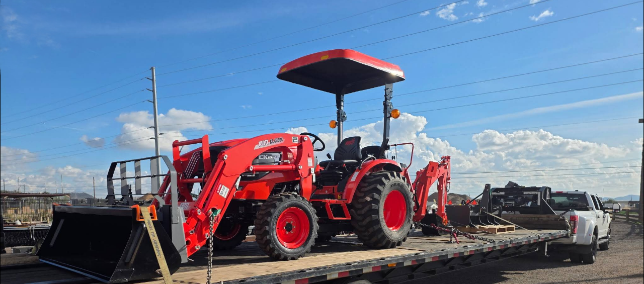 KIOTI tractor with a color-matched Tractor Sunshade canopy mounted above the operator station.