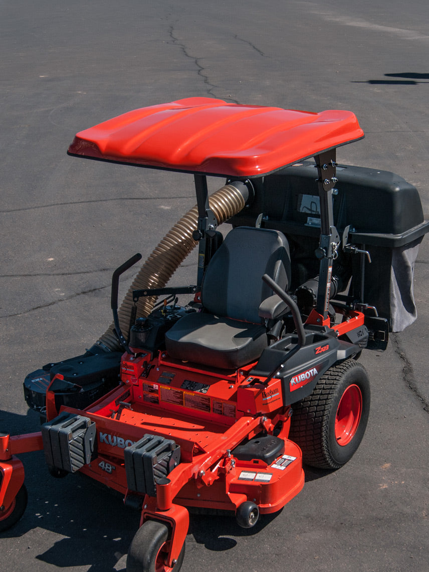 Orange Kubota commercial zero-turn mower equipped with a matching Tractor Sunshade N-Series canopy, viewed from the front-left side.