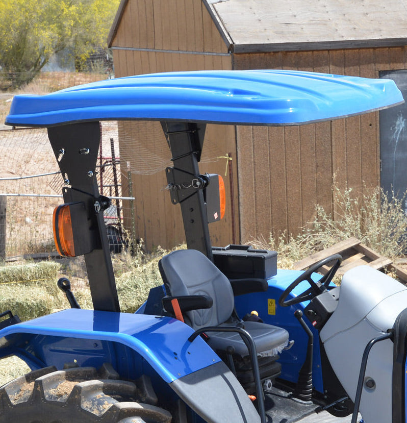 New Holland tractor equipped with a blue Tractor Sunshade N-Series fiberglass canopy.