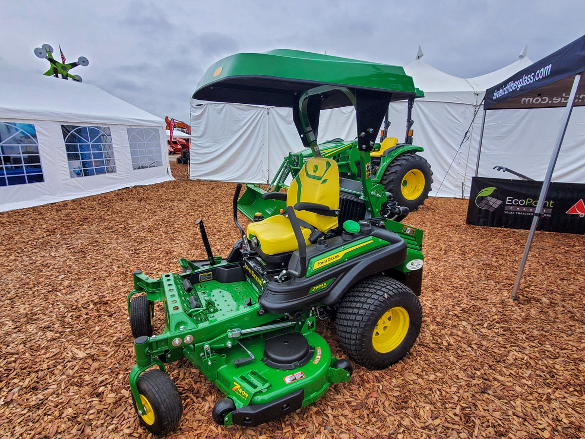 John Deere commercial zero-turn mower equipped with a green Tractor Sunshade R1 R-Series canopy.