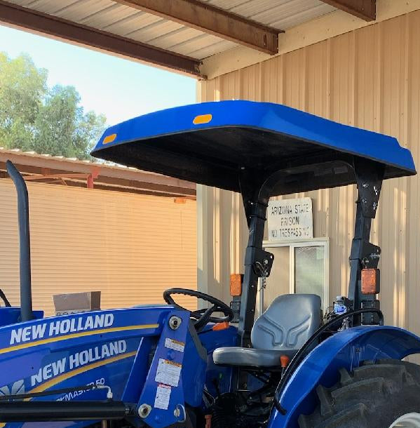 Blue New Holland tractor equipped with a matching Tractor Sunshade R-Series fiberglass canopy.