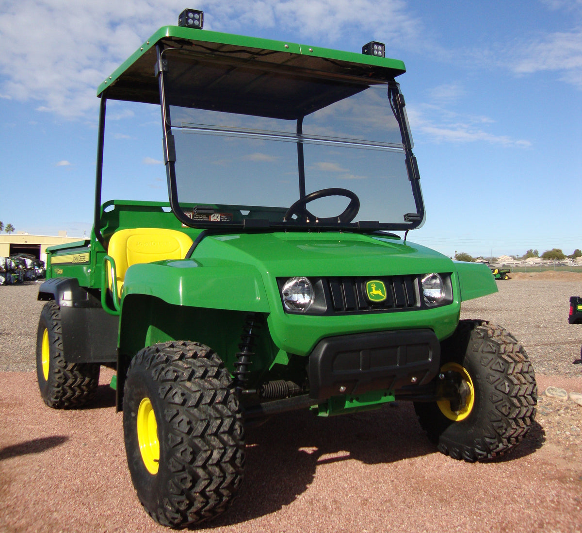 John Deere Gator utility vehicle equipped with a green Tractor Sunshade GTS fiberglass canopy.